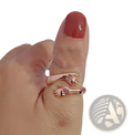 Adjustable rose gold ring with two interlocking hands design featuring a red gemstone in silver material