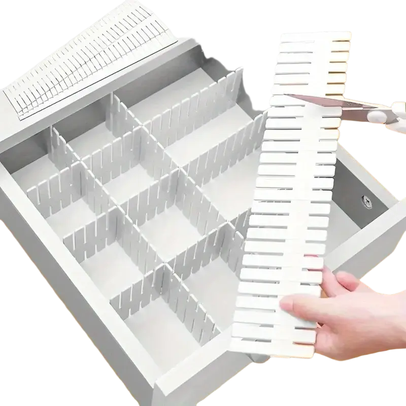 Adjustable white plastic drawer divider partition with slatted interlocking design for organized storage spaces