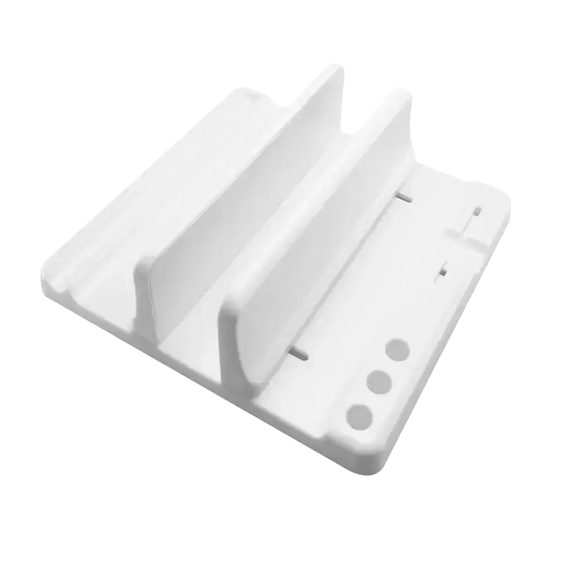 White plastic adjustable width laptop and tablet stand with two vertical slots and three circular holes on base showing opening size