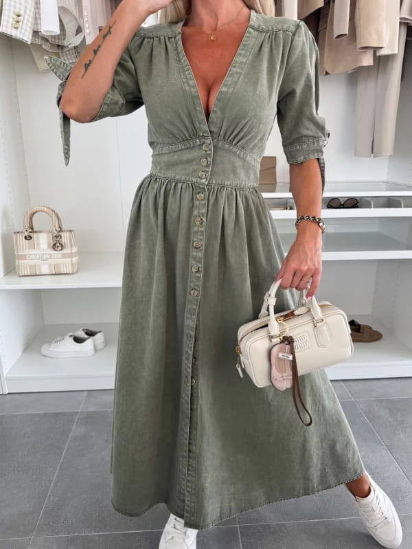 Olive green button-down midi dress made of denim with puffed sleeves and a cinched waist.