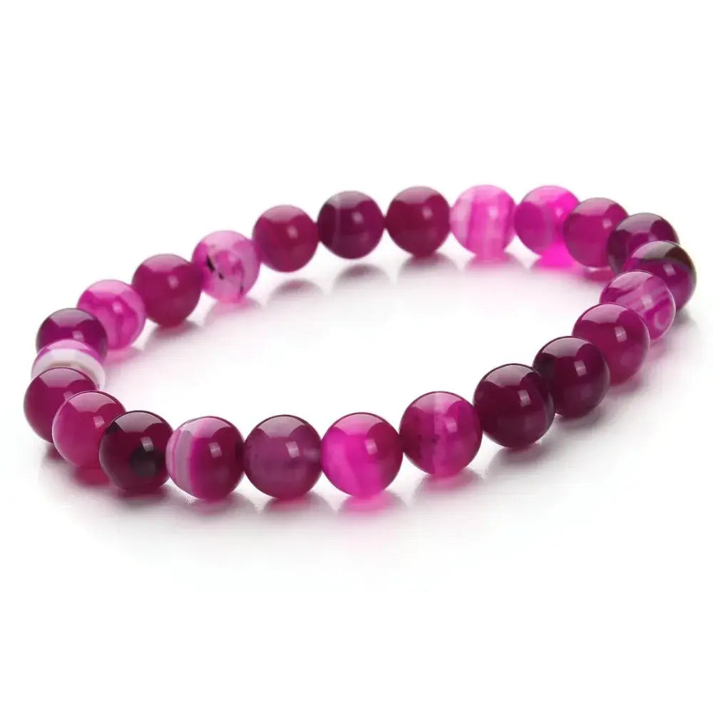 Natural polished gemstone and agate beaded bracelet featuring vibrant pink and magenta smooth polished spheres.