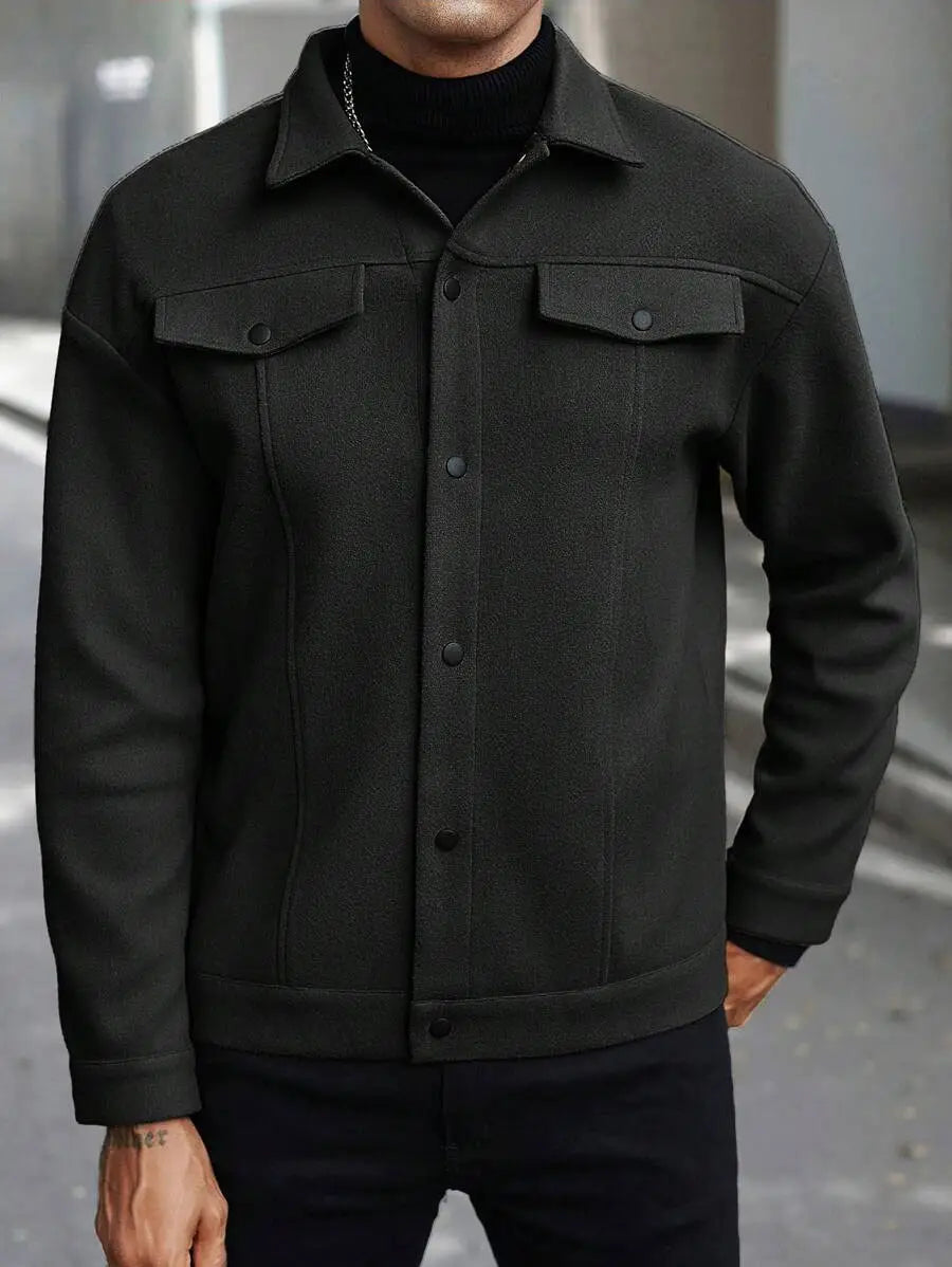 Men’s classic slim fit wool blend lapel jacket in black denim featuring two chest pockets and a button-up front.
