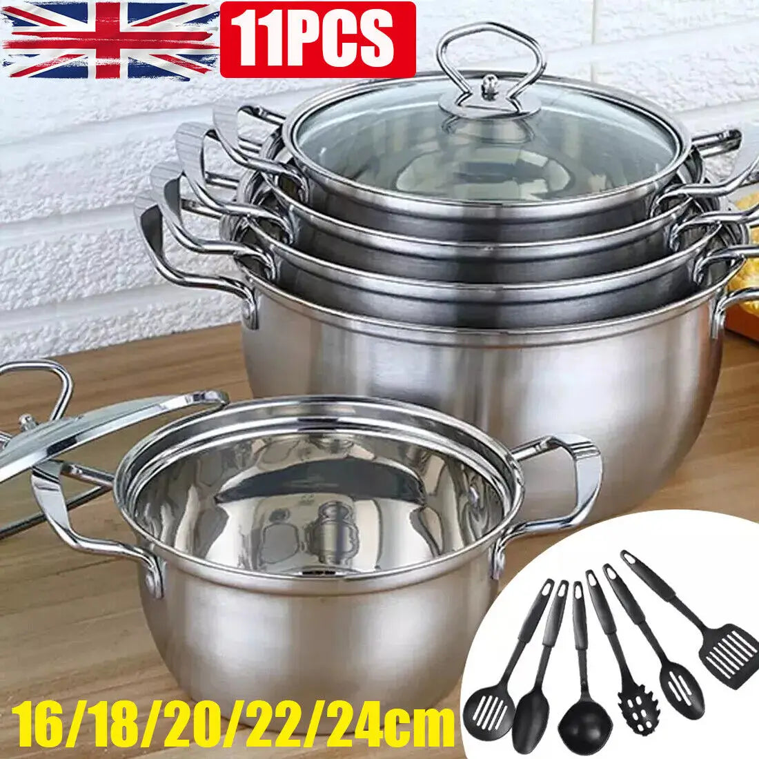 Set of stainless steel induction cookware with glass lids and matching black silicone cooking utensils in an 11 piece set.