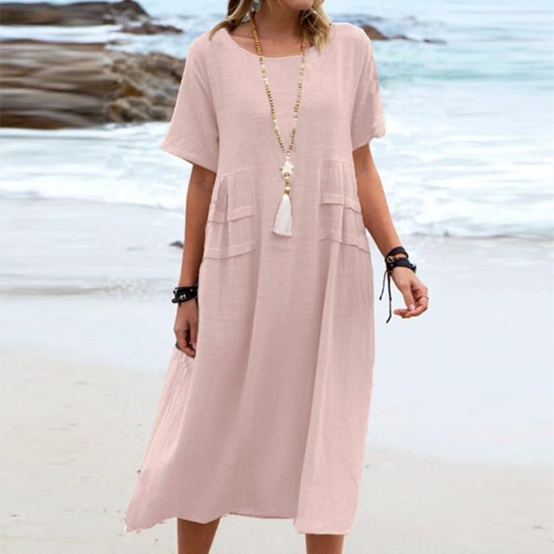 A soft pink loose linen short sleeve midi beach dress with tiered pockets designed for women.