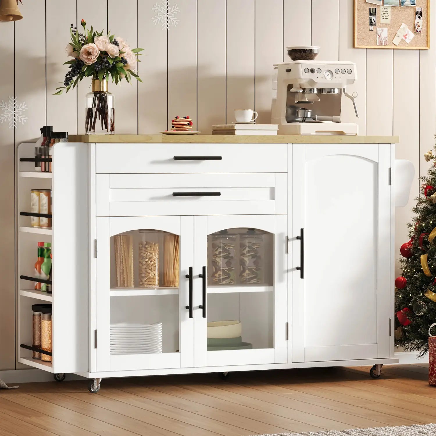 White mobile kitchen island with foldable worktop, light wood countertop, black handles, glass-paneled doors, and wheels for easy mobility.