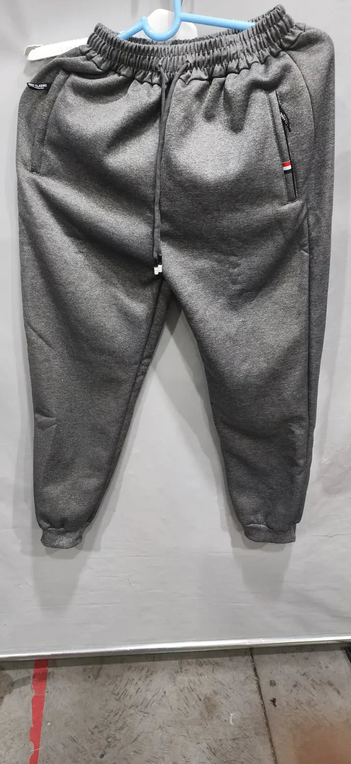 Gray heathered fleece lined mens winter jogger pants with elastic waistband drawstring and side pockets with zipper accents.