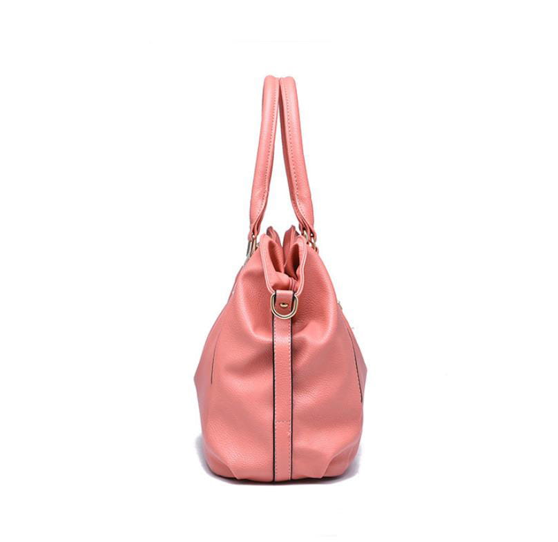 A soft pink pu leather women tote bag with high capacity shoulder design featuring a drawstring closure and gold-tone hardware.