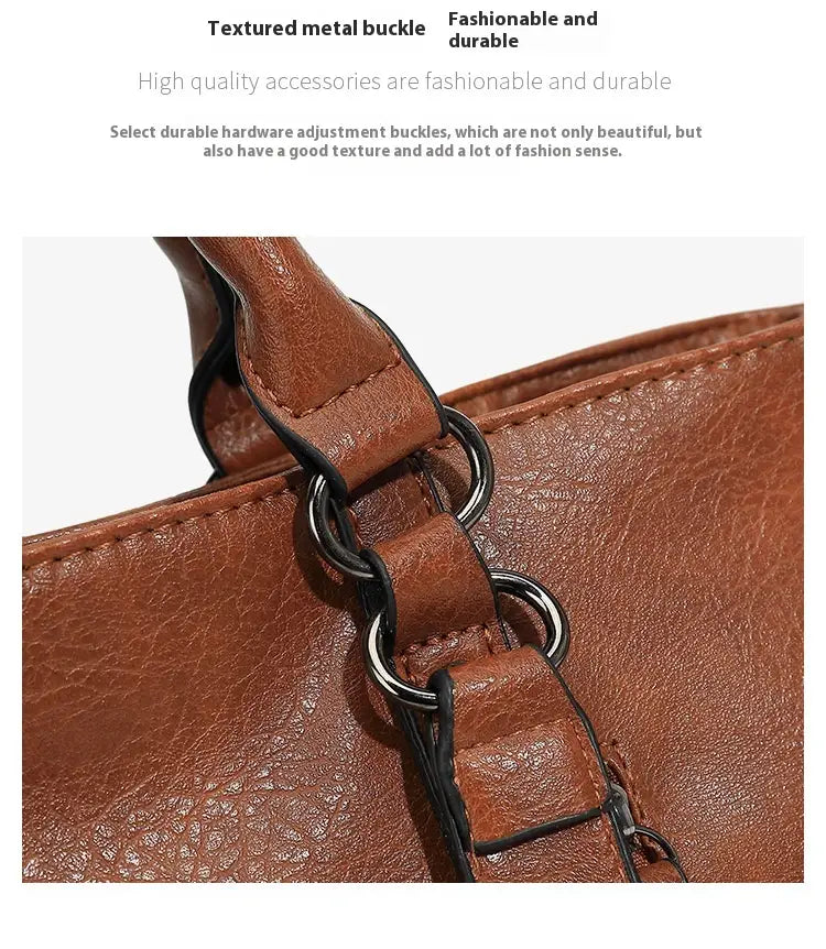 Brown leather tote bag with large capacity featuring a shoulder strap and a textured metal buckle.