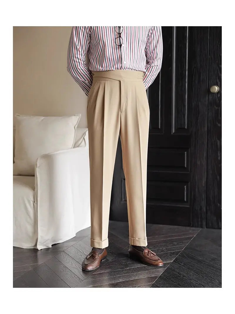 Beige tailored pleated wool straight leg trousers with rolled cuffs for men.