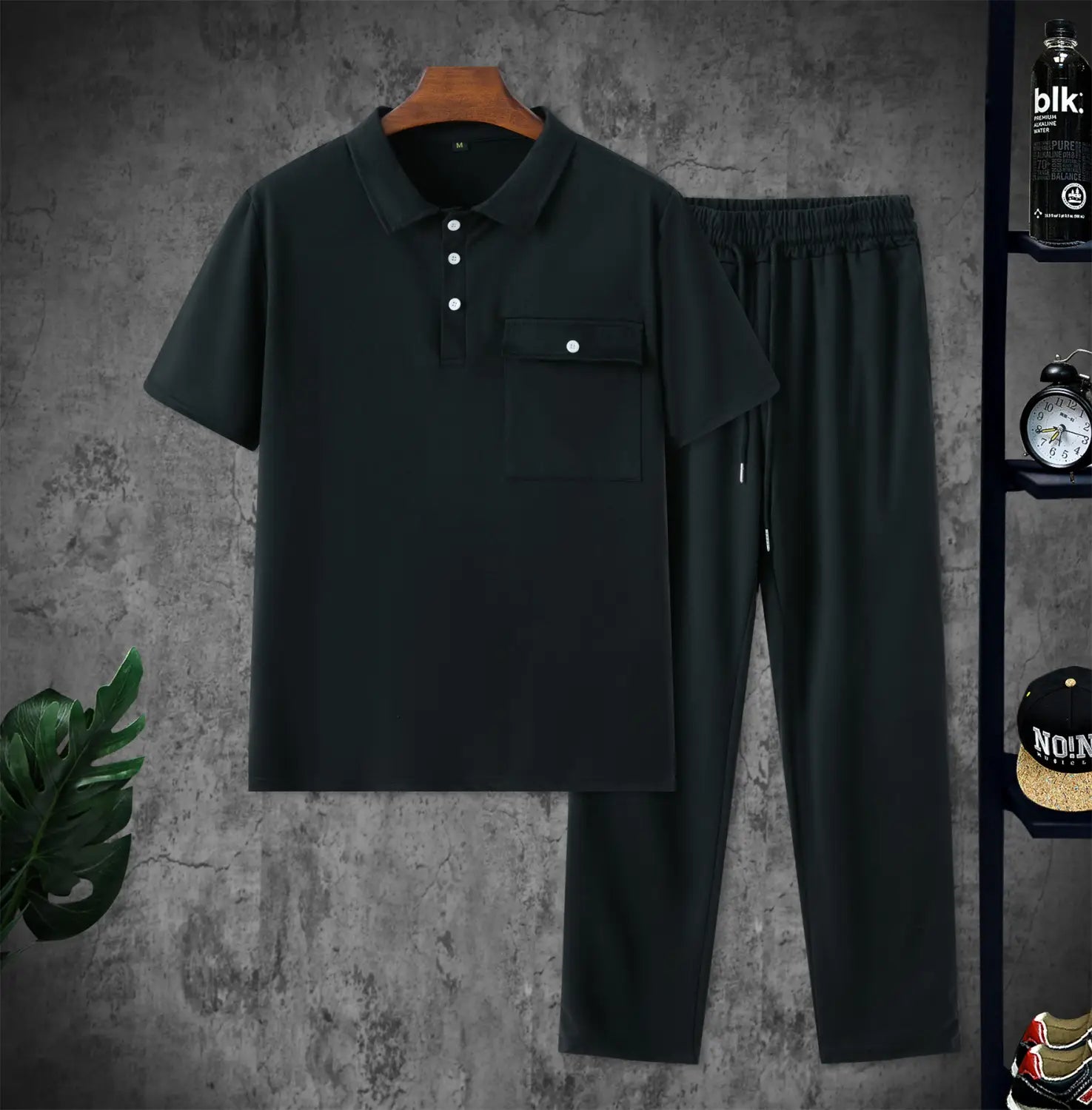 men short sleeve polo shirt and pants set featuring a black cotton polo shirt with white buttons and chest pocket paired with matching black drawstring pants.