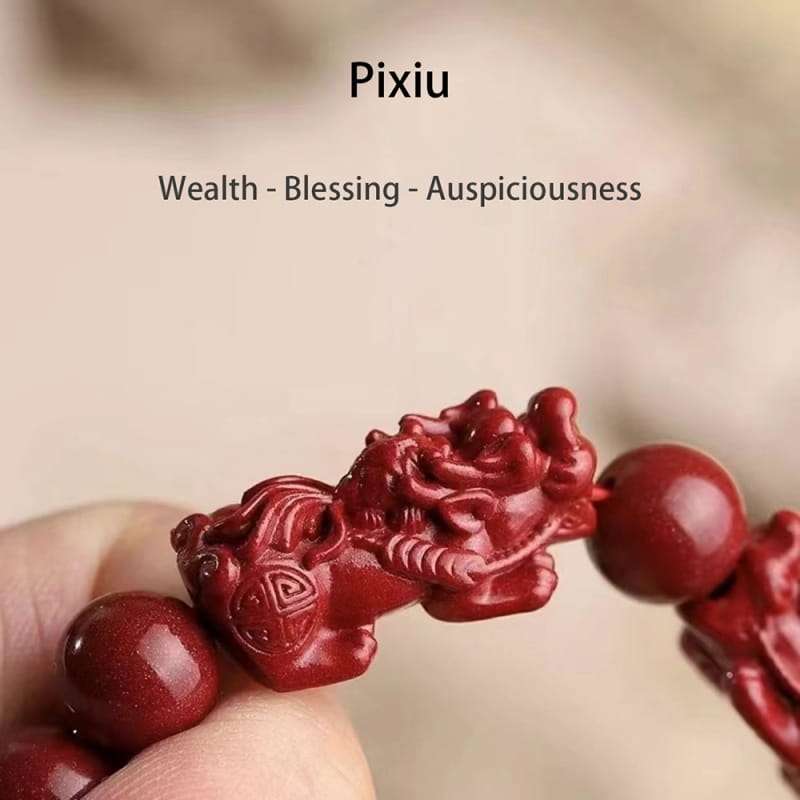 red carved pixiu charm bead on a hand carved purple gold cinnabar double pixiu bracelet made of cinnabar material