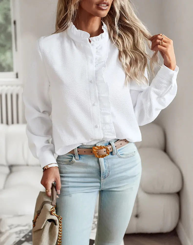 White textured long sleeve button up blouse featuring a ruffle trim collar and made from lightweight fabric for a polished and stylish look.