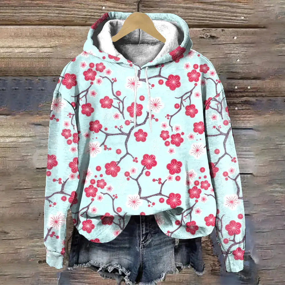 Sudadera con capucha de ajuste holgado con estampado floral azul claro, con un vibrante patrón de flor de cerezo roja, ramas de color gris oscuro, capucha forrada de gris acogedor y cordones blancos.