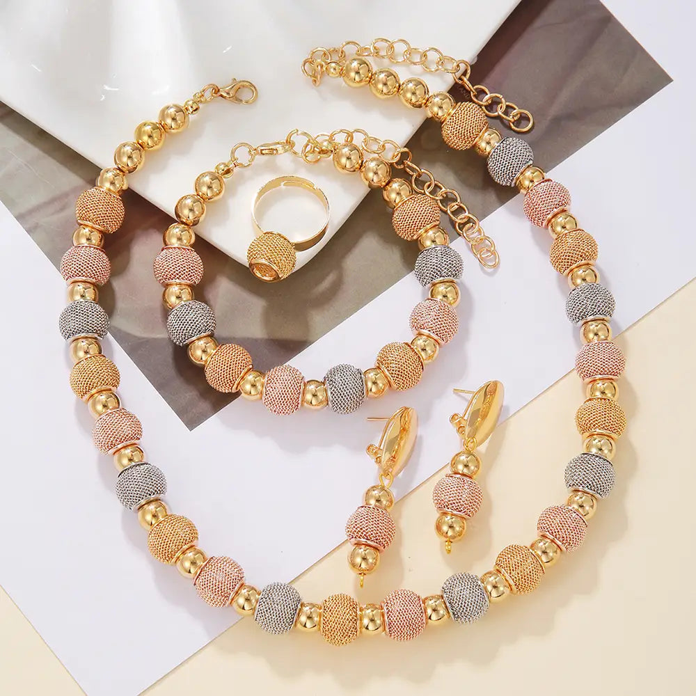 Gold-toned and rose gold beaded necklace with textured spherical beads in a tri-color pattern of metallic gold, rose gold, and silver from the 5-piece tri-tone metallic beaded jewelry set.