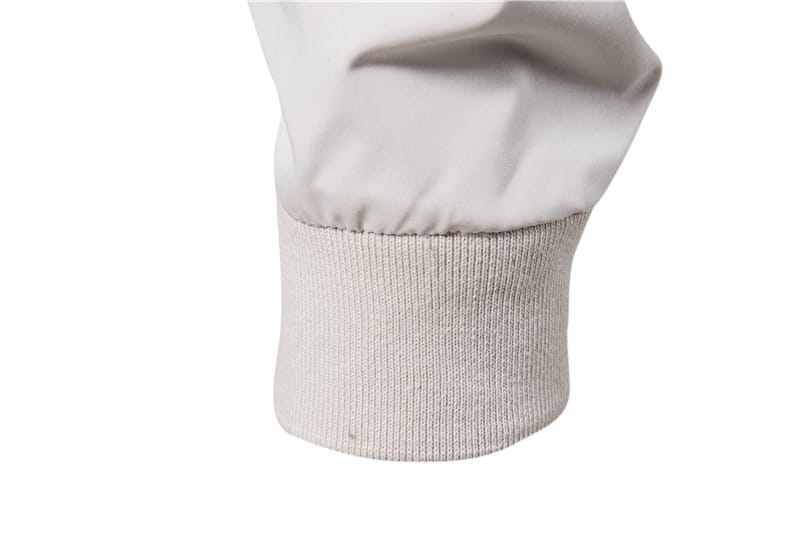 The cuff of a light gray ribbed knit sleeve with smooth fabric above is part of a men’s bomber jacket casual zip outerwear.