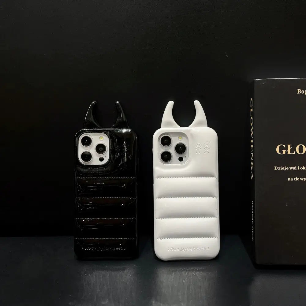 Black and white puffer-style quilted leather iPhone cases with devil horn protrusions on the back side.