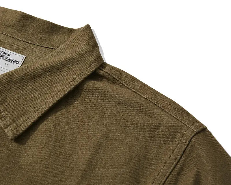 Mens french workwear jacket cotton utility pocket coat in olive green featuring a classic collar and neatly stitched seams.