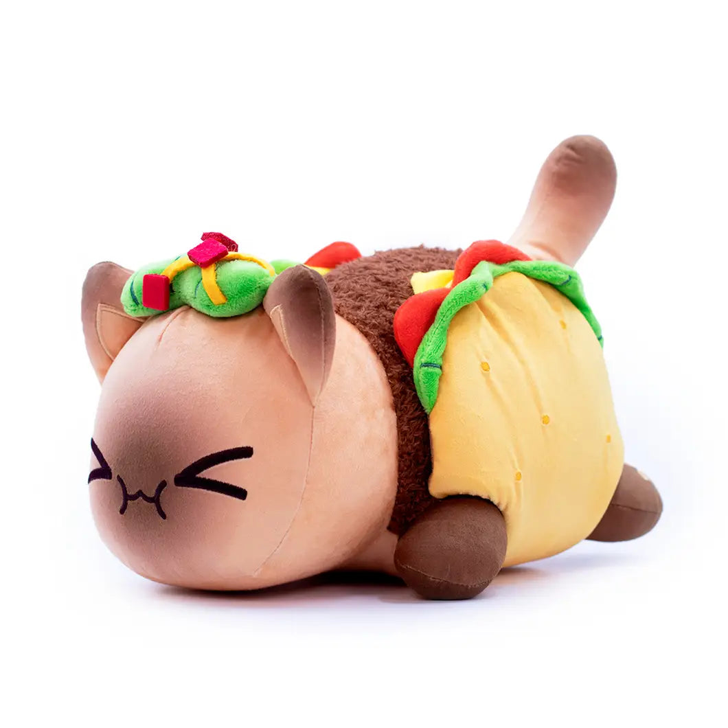 Cute brown cat plush stuffed animal toy for kids 25cm with closed eyes and a taco-shaped body featuring yellow tortilla, green lettuce, red tomato slices, and colorful ribbon accents.