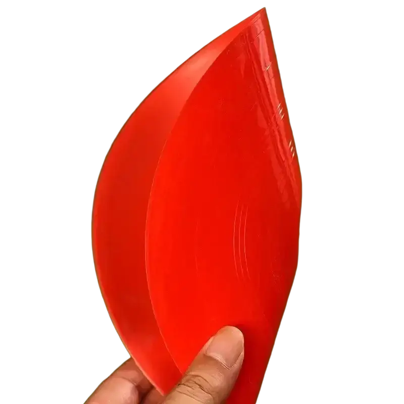 A vibrant red glossy plastic leaf-shaped agility soccer training cone held in a hand for soccer training use