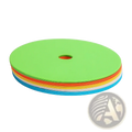 Stack of ten colorful circular foam agility training cones in green orange yellow white and blue for sports marking