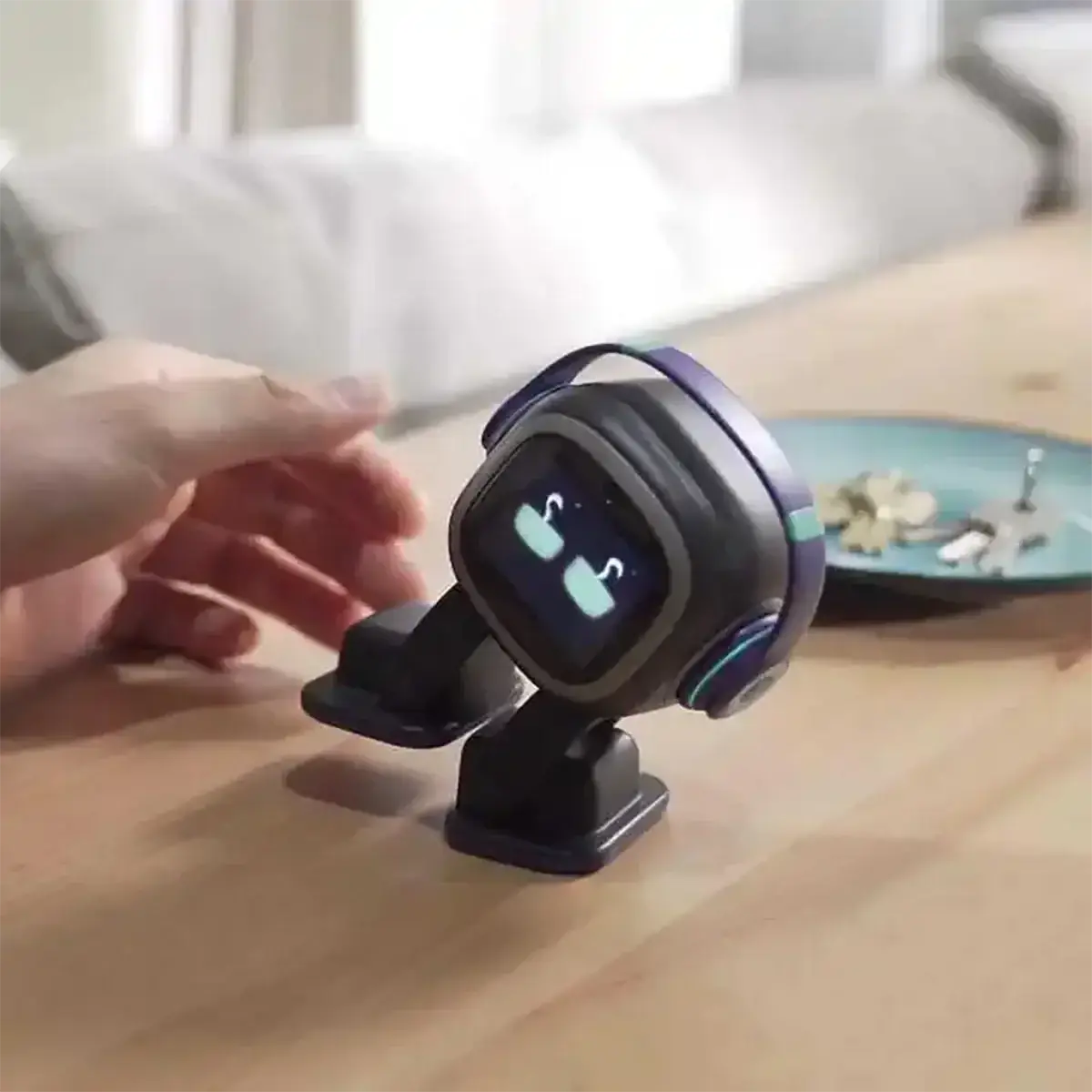 A compact black and purple ai smart companion robot toy with a glowing screen displaying cartoon eyes