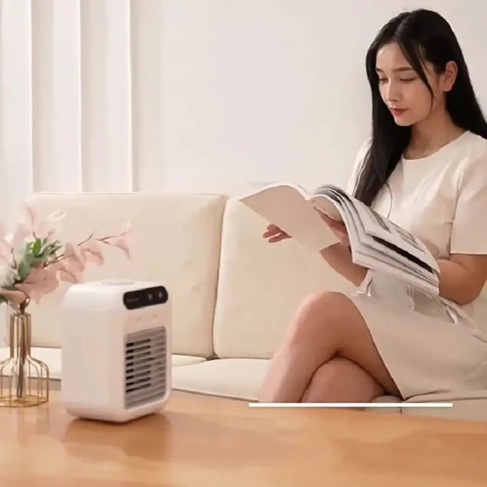White compact portable mini evaporative air cooler and humidifier with black control panel and front grille
