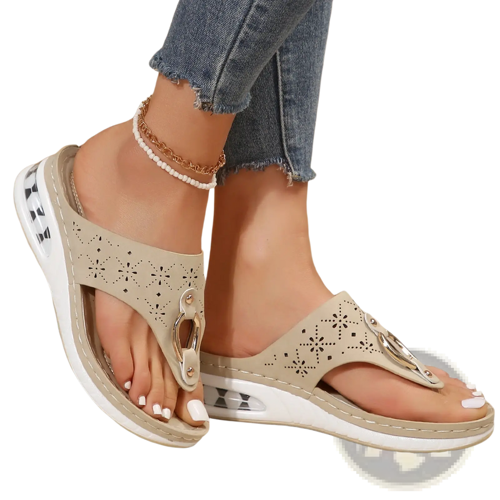 Beige perforated leather air cushion thong sandals with silver metal accents and white cushioned sole wedge flip flops