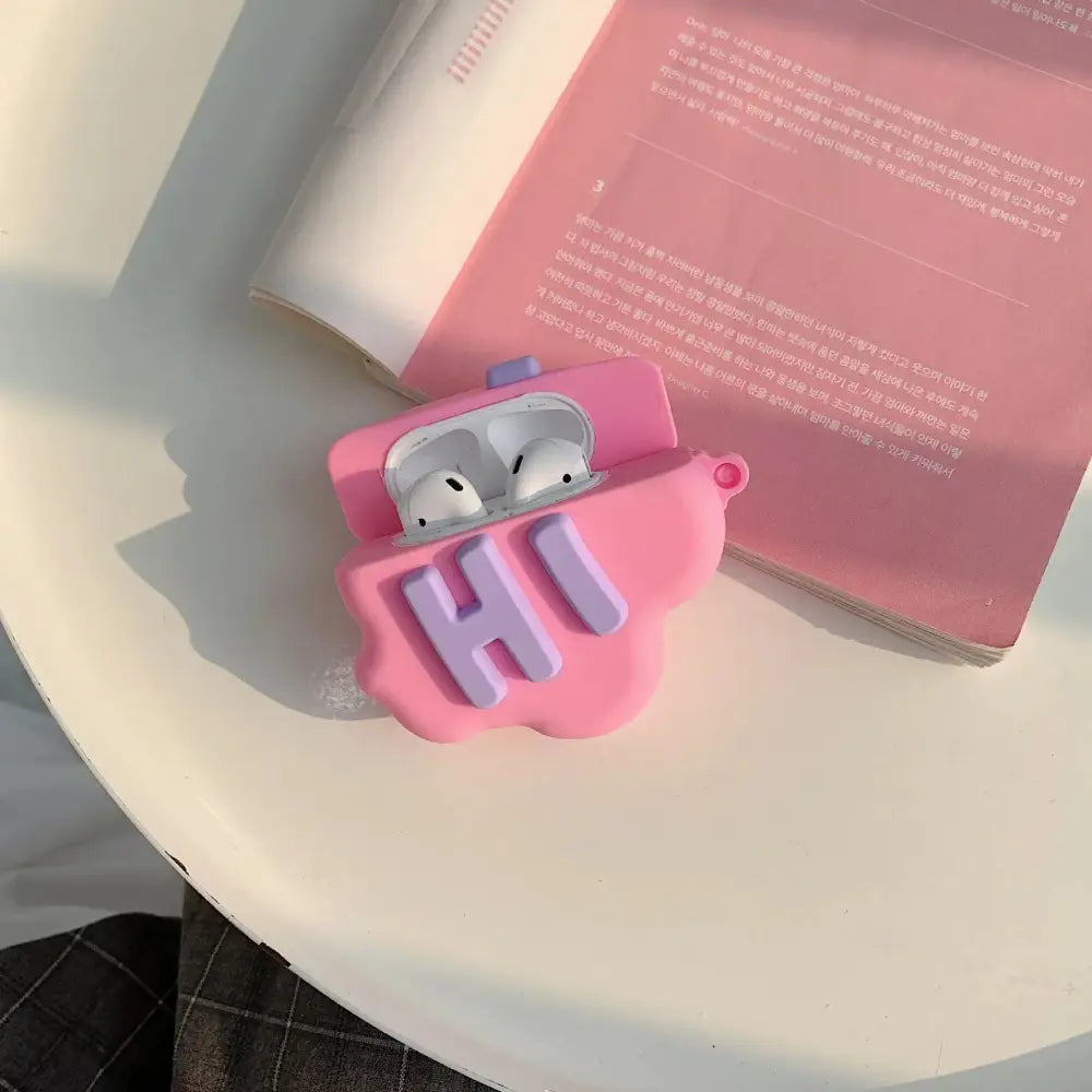 Pink silicone 3d hi bye speech bubble AirPods 2 case with purple hi lettering and a small blue button on top