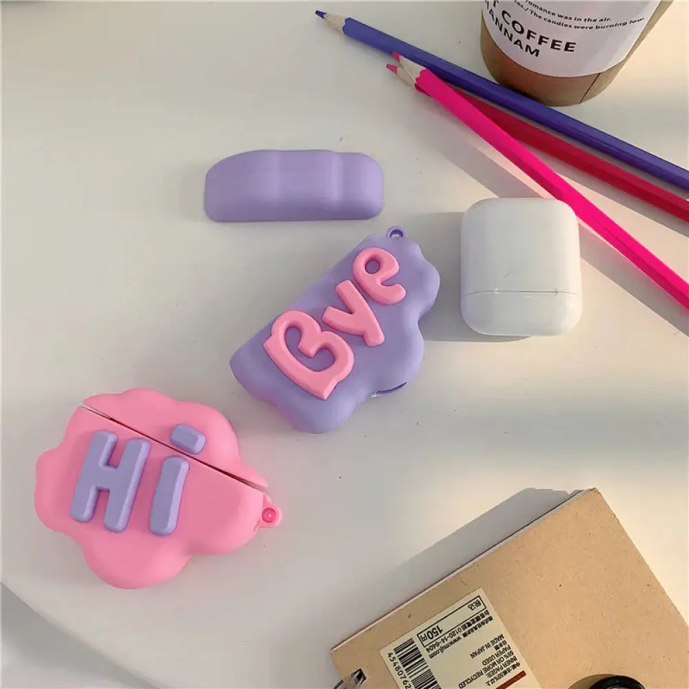 Pastel purple and pink silicone airpods 2 case with 3d hi bye speech bubble lettering on the front side