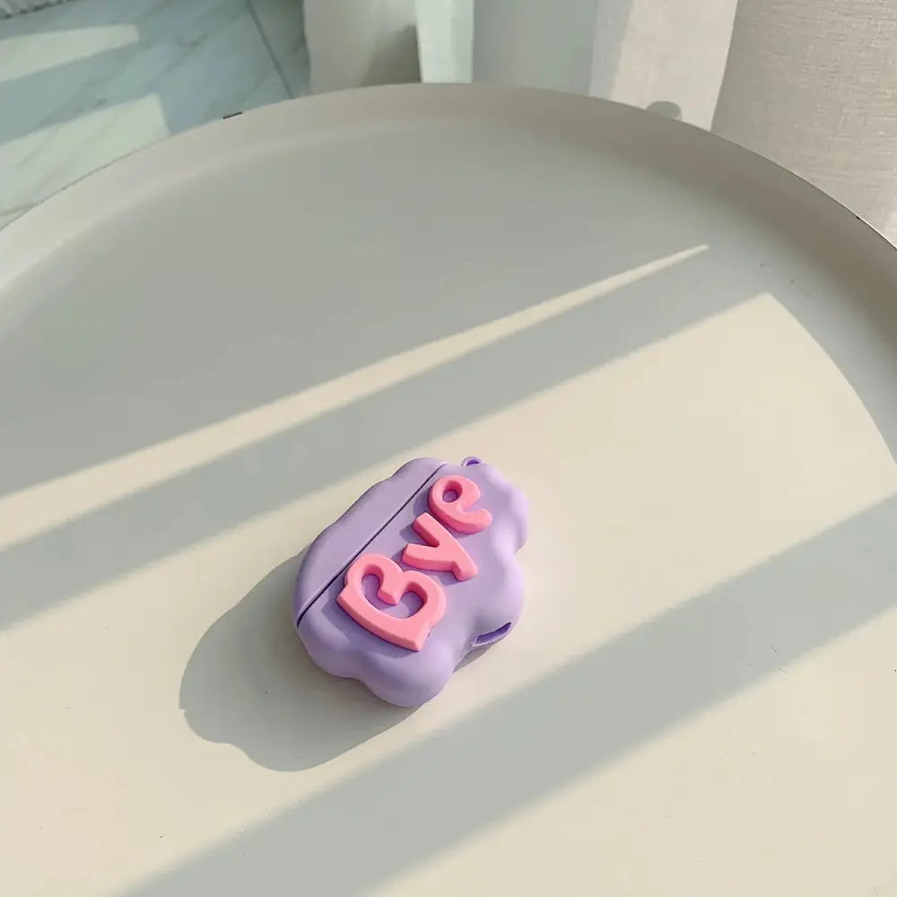 A soft lavender silicone 3d bye lettering case designed to fit an airpods pro charging case