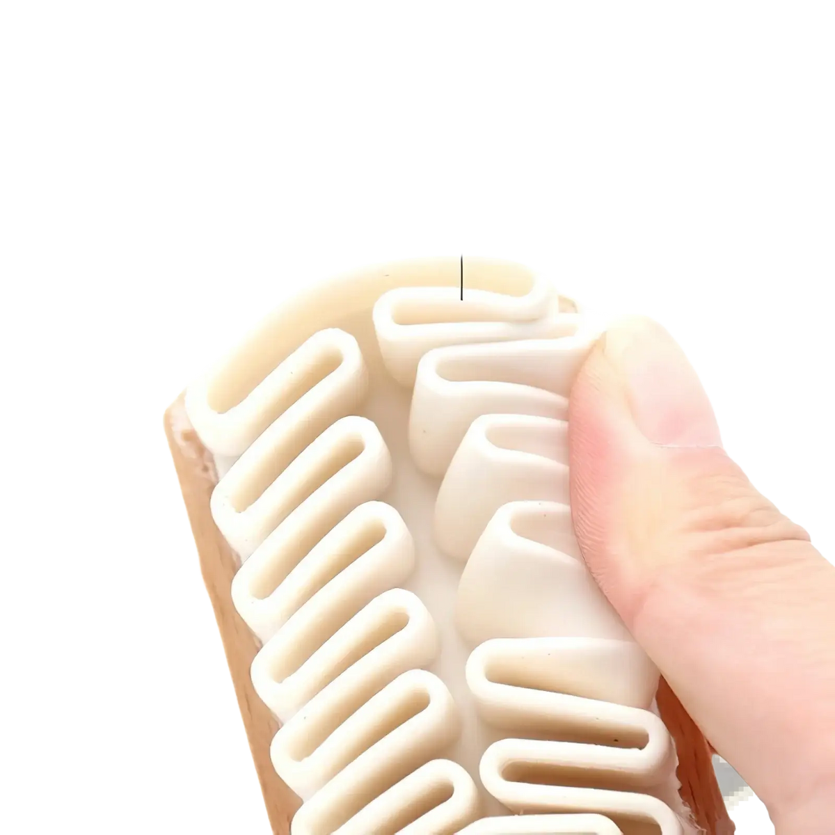 A cream-colored alcantara suede car interior cleaning brush with soft rubber bristles and a wooden handle