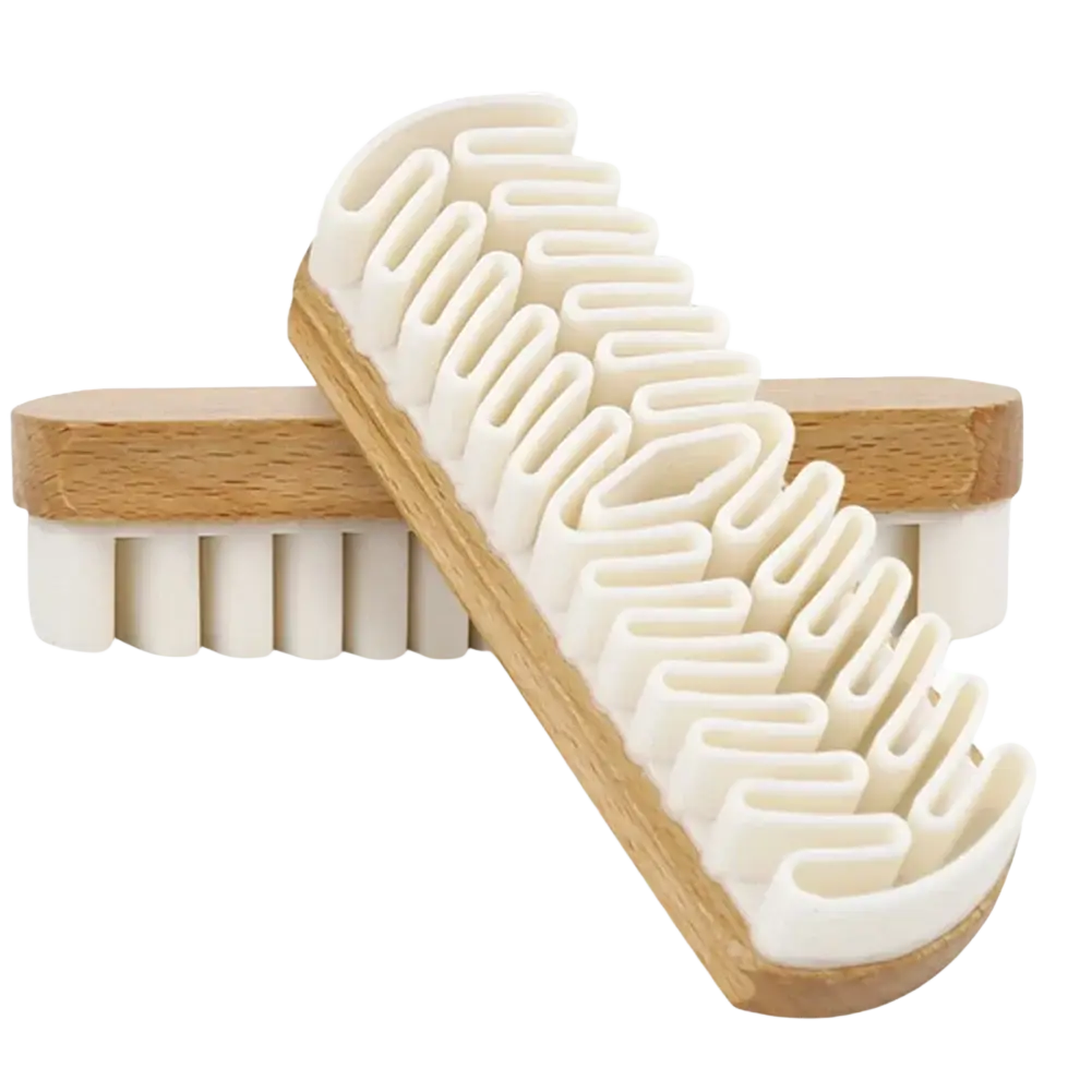 White plastic shoe brush with natural wood handle and uniquely shaped bristles for alcantara suede car interior cleaning