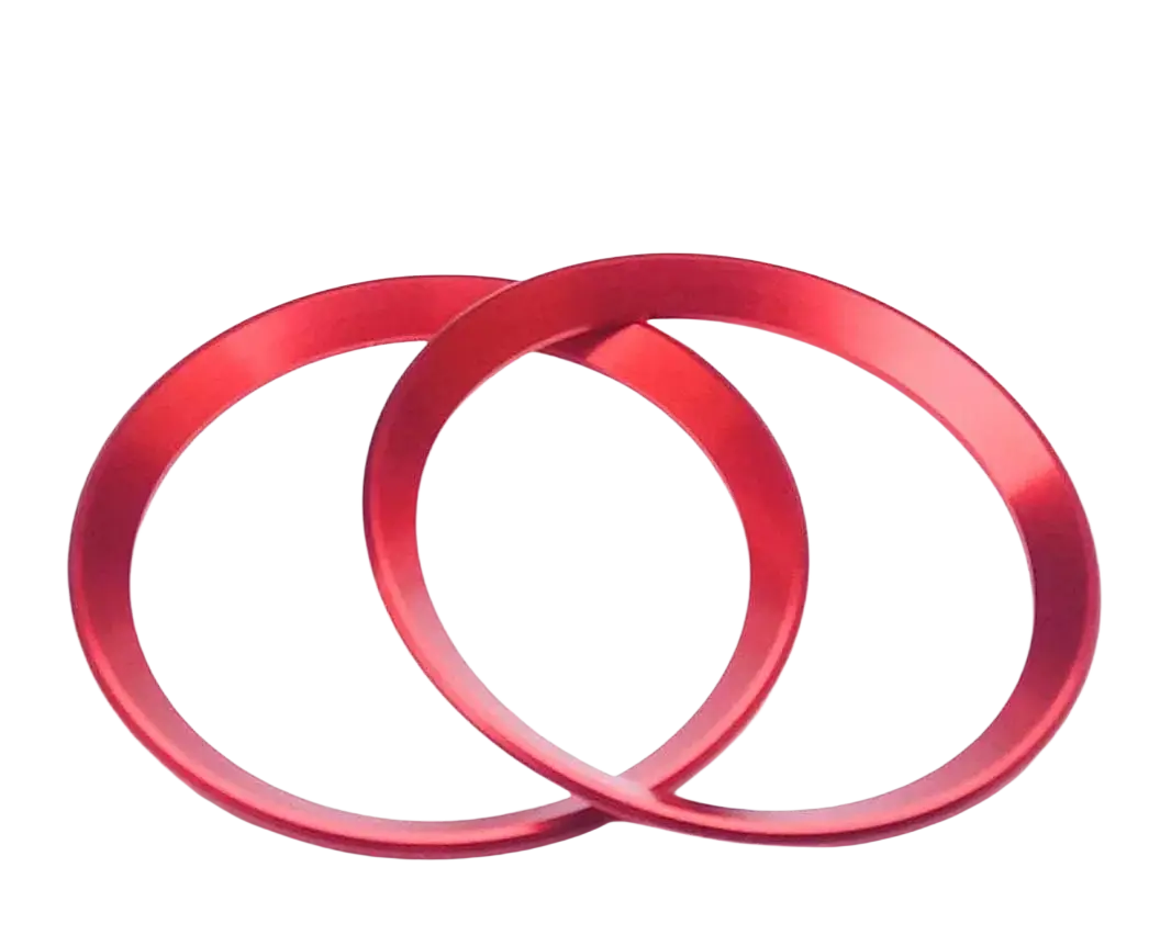 Two vibrant red metallic Alfa Romeo Giulia Stelvio air vent trim rings with a sleek brushed finish