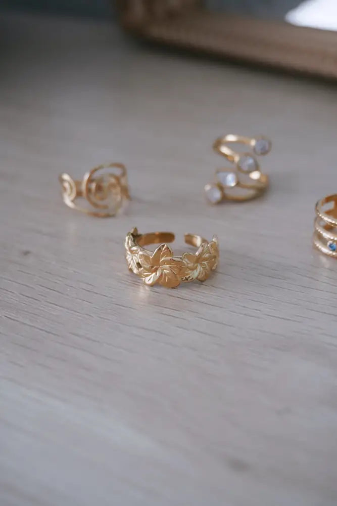Aloha gold tropical flower statement ring with gold-toned open band and delicate raised leaf pattern design