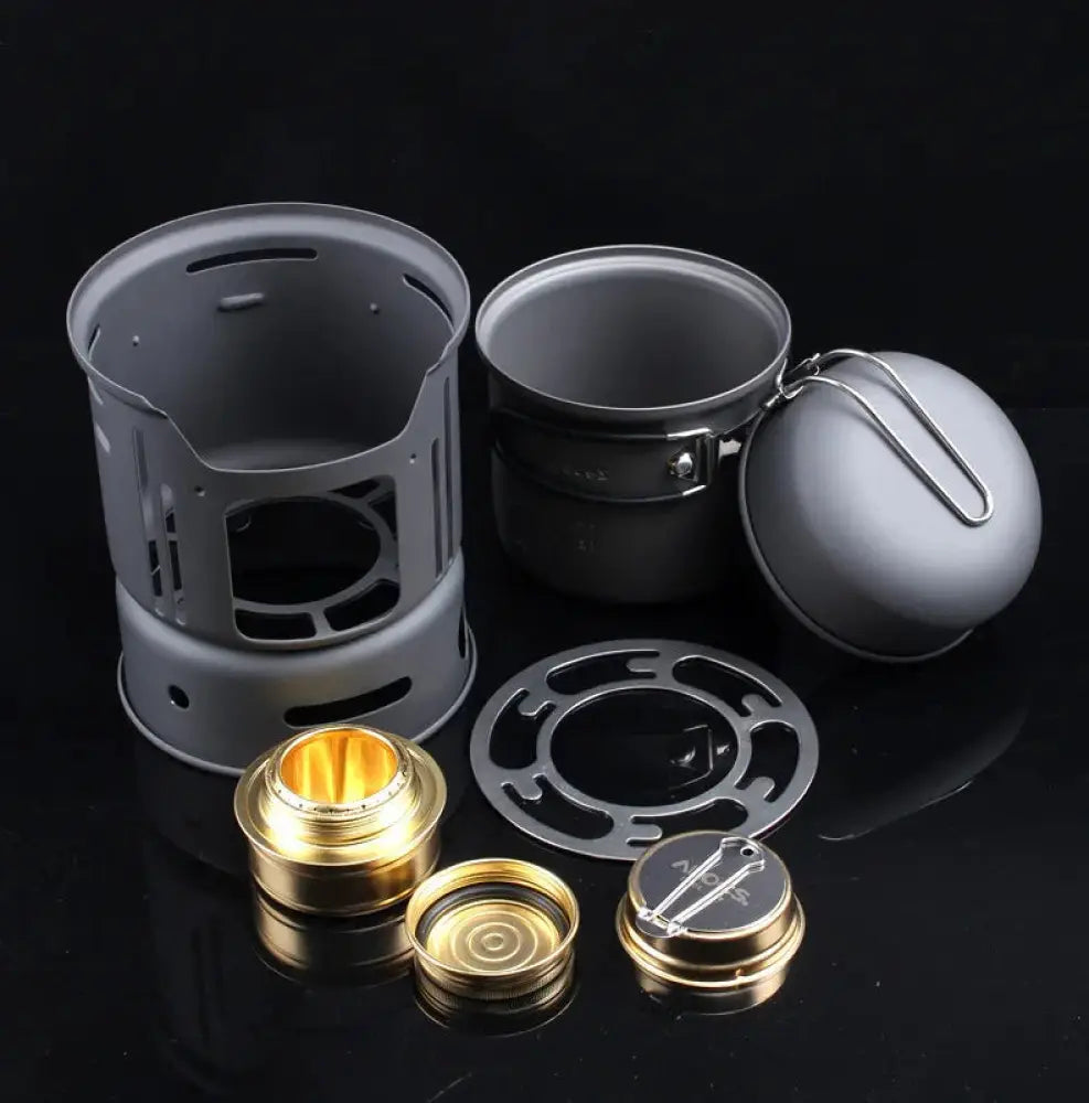 Gray aluminum portable camping stove set with gold burner components and matching pot for outdoor cooking