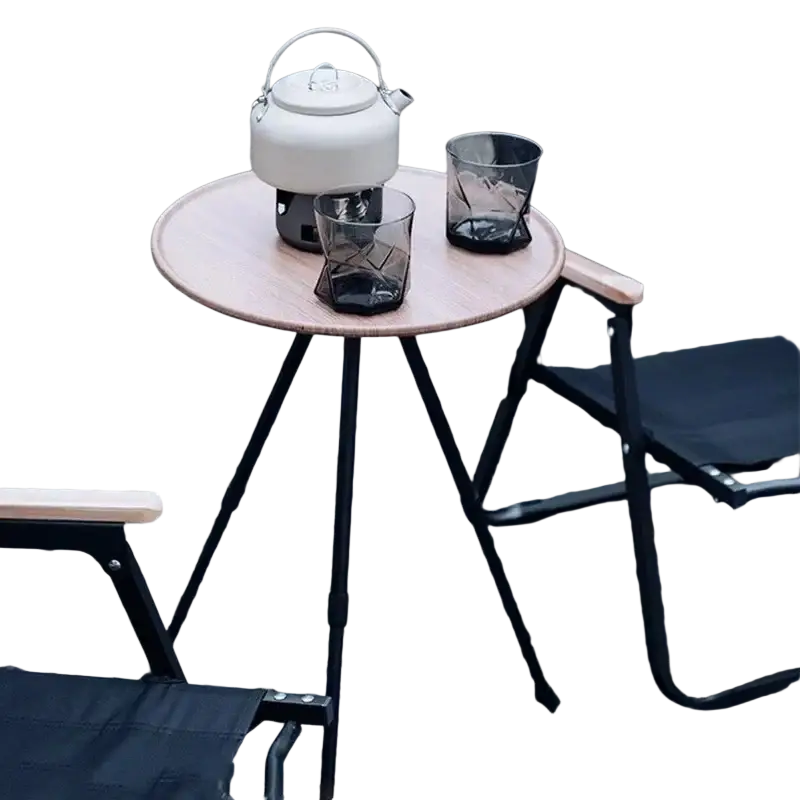 White ceramic teapot with silver handle and lid on aluminum alloy folding camping table with portable stove