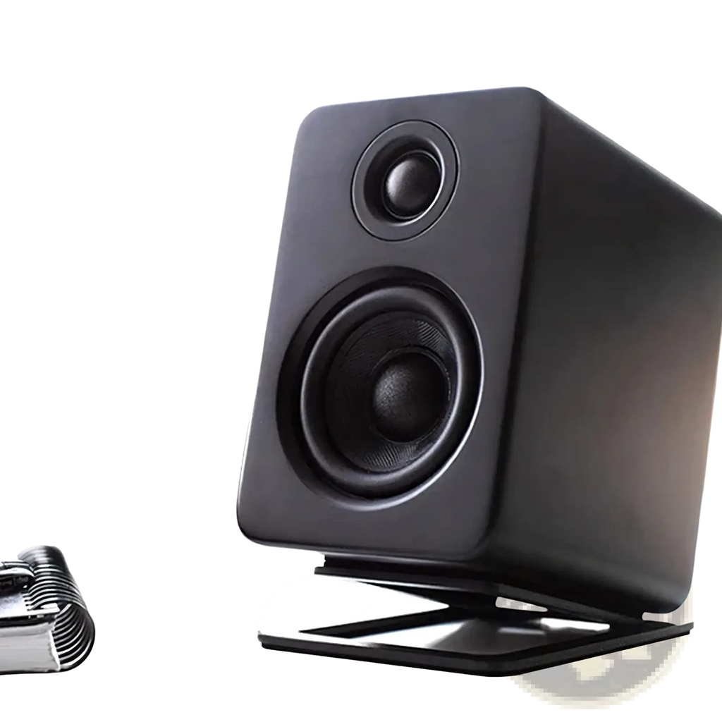 Black rectangular studio monitor speaker with matte finish and two circular drivers on aluminum desktop speaker stands with 16° tilt