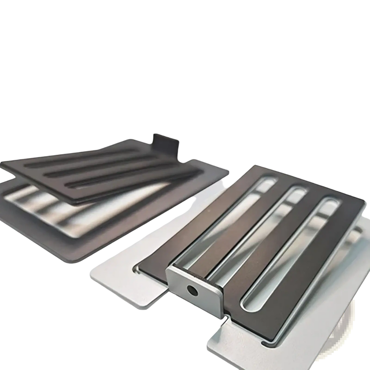 Modern black and silver metal toaster crumb trays with sleek minimalist design shown alongside aluminum desktop speaker stands with 16 degree tilt