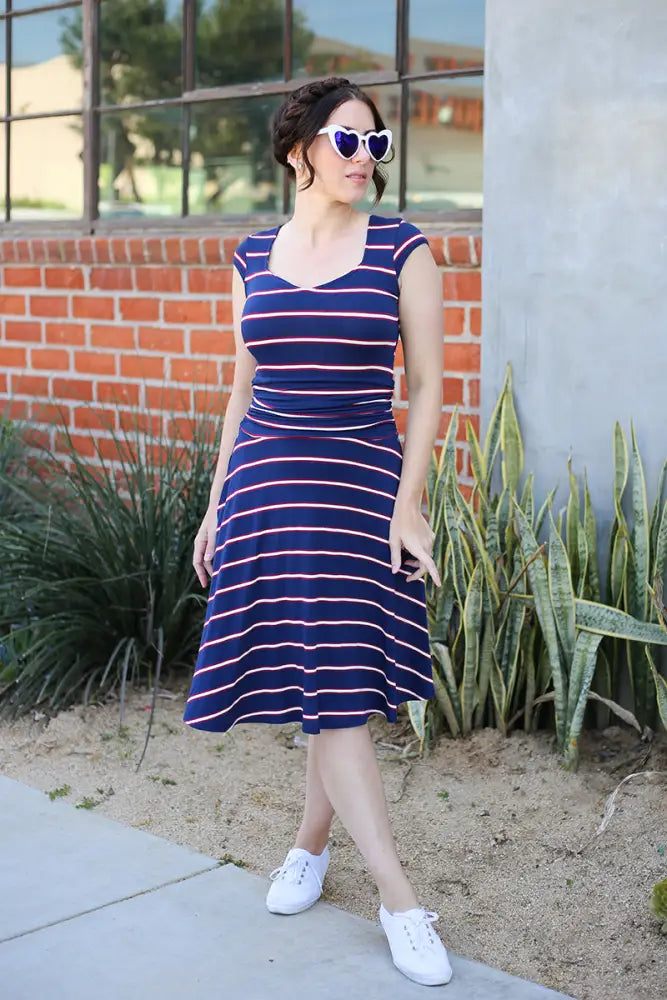 Amelia navy and pink striped 1950s style midi dress with fitted bodice and flared skirt in navy blue and coral