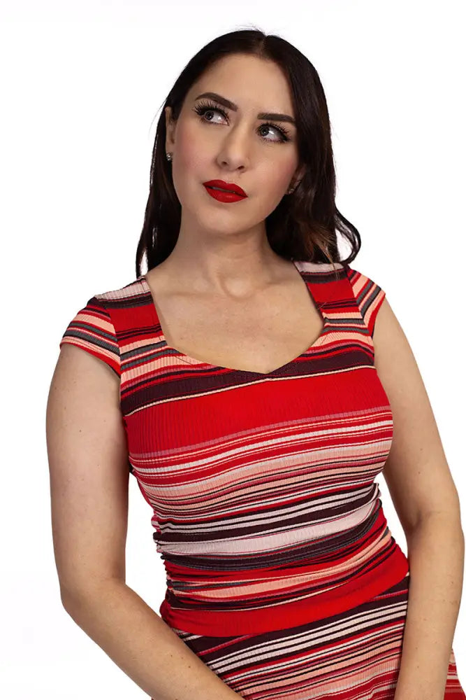 A woman wearing an amelia retro striped cap sleeve fit and flare dress in red black and white ribbed fabric