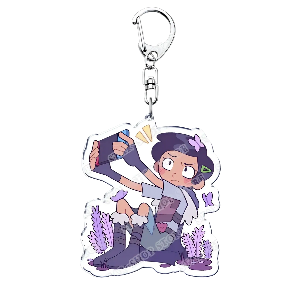 Purple and white acrylic Amphibia anime keychain featuring a cartoon character taking a selfie with a smartphone