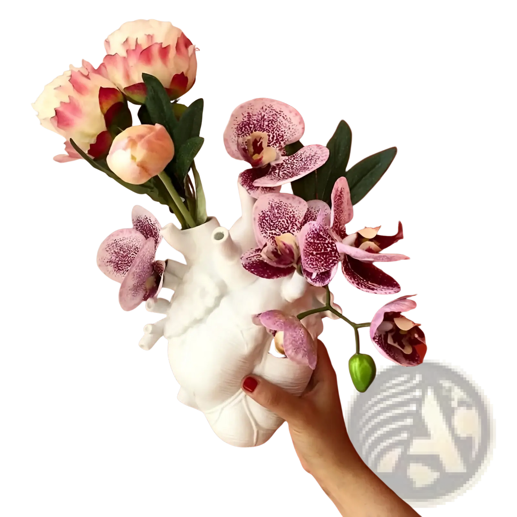 White ceramic anatomical heart vase holding pink and white orchids and roses for Nordic resin sculpture decor