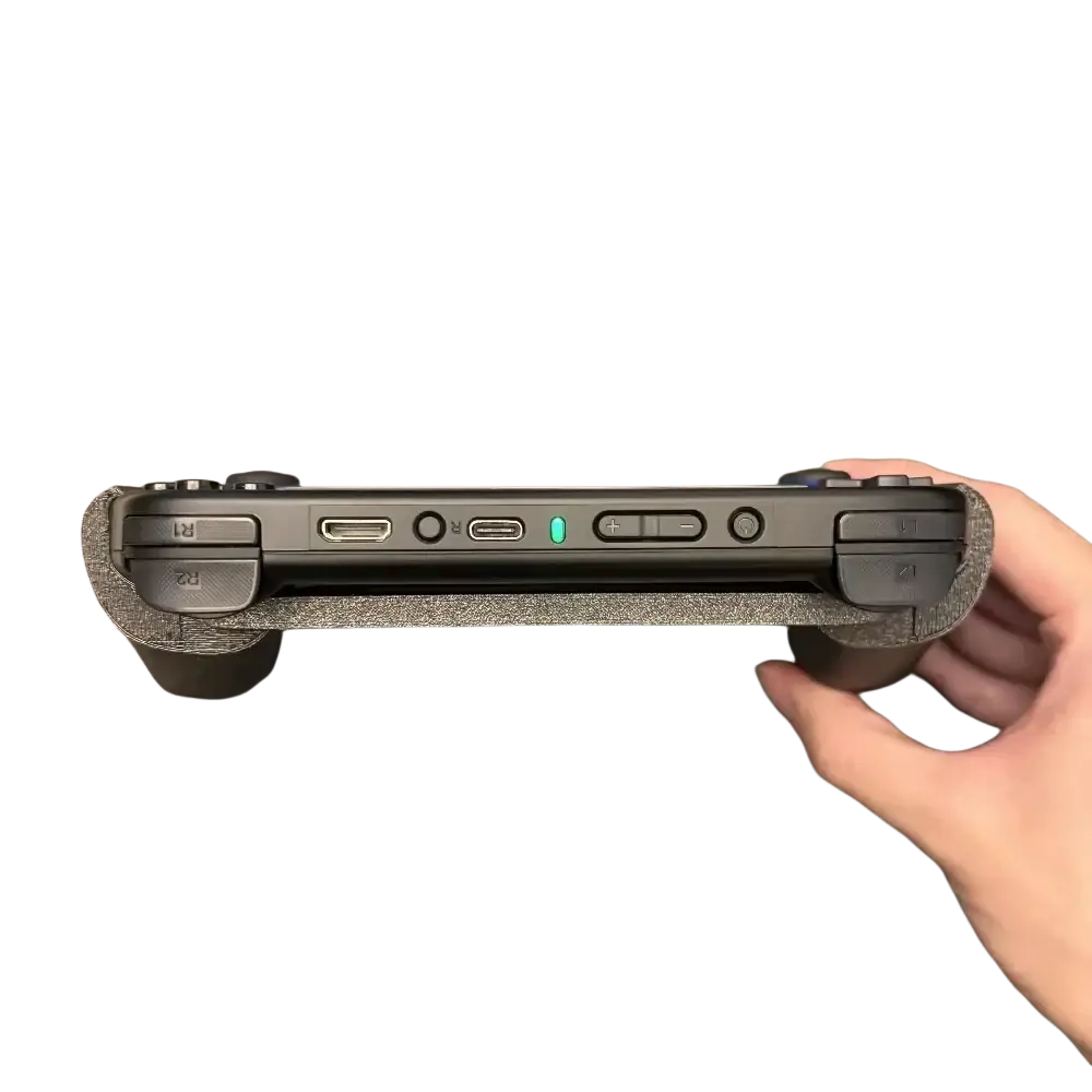 Black anbernic rg40xx handheld gaming console with ergonomic textured grip pads and glowing green power indicator light
