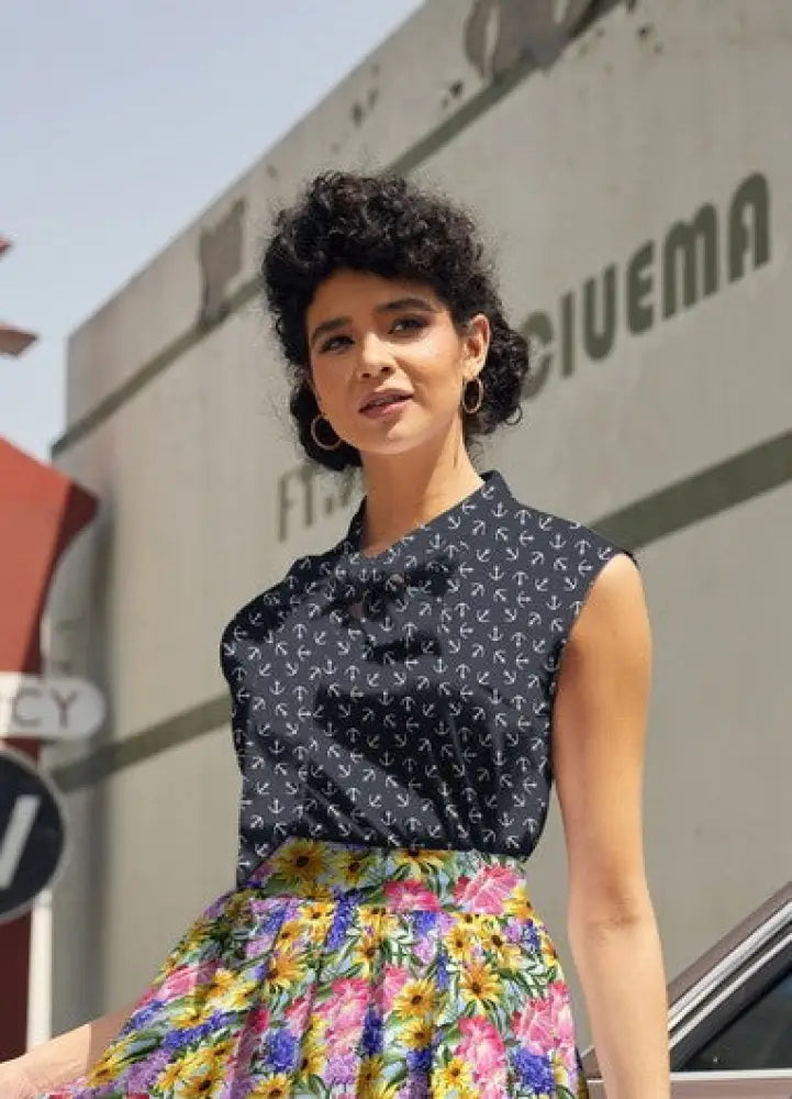 A navy blue sleeveless blouse with a subtle anchor pattern and gathered neckline vintage navy anchor print bow top
