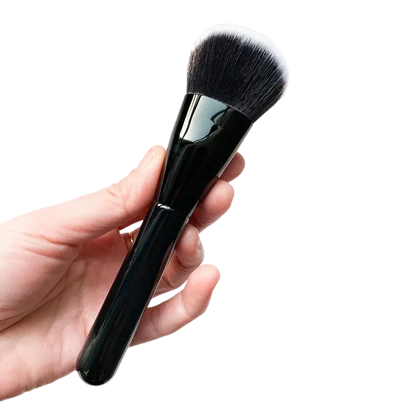Angled foundation makeup brush with black synthetic bristles and a sleek glossy handle displayed from the back side