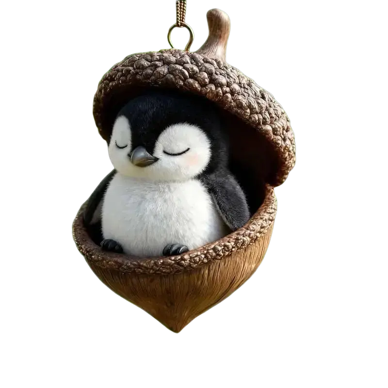 Cute black-and-white plush penguin nestled in a brown acorn-shaped acrylic animal Christmas ornament for tree decor