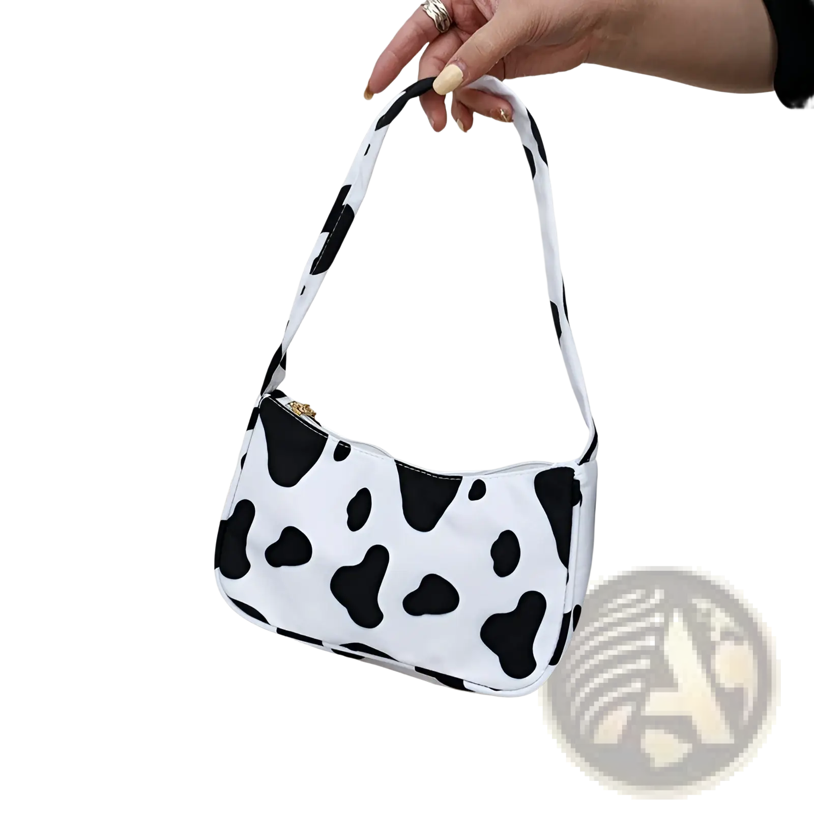 Animal print underarm shoulder bag for women in white with black cow print pattern and gold-tone zipper closure