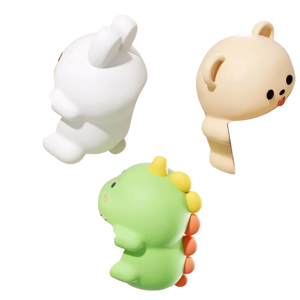 Animal table corner protector made of soft silicone in white beige and green with yellow and orange spikes for baby safety