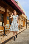 Animal Town Greta v-neck cotton holiday dress in white with a black floral pattern and short sleeves