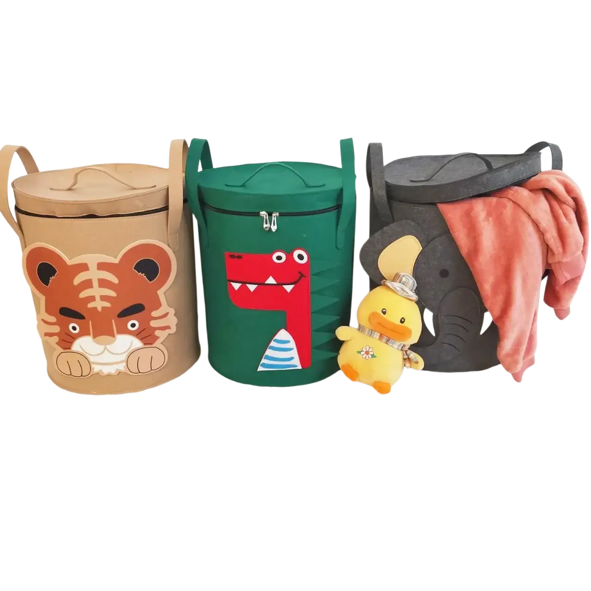 Three cylindrical fabric animal toy storage baskets with lids and handles in tan tiger, green dinosaur, and black elephant designs